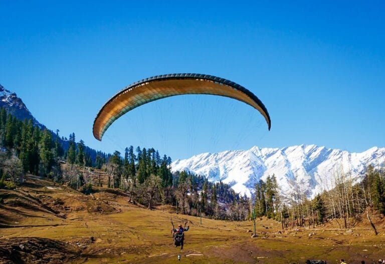 Tourist paragliding over Solang Valley mountains in Manali Himachal Pradesh