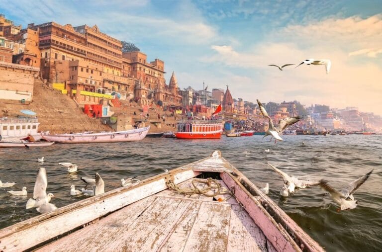 Wooden boat on the Ganga River with a view of Varanasi Ghats