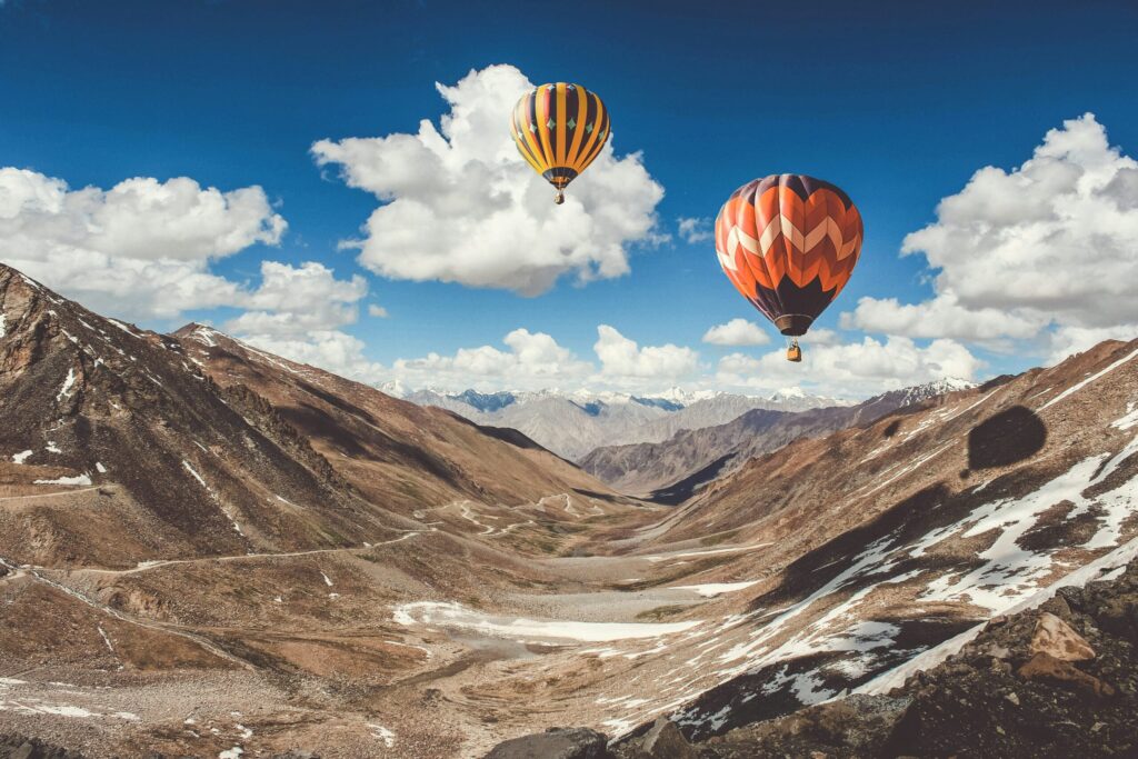 Hot air balloon ride over mountainous North India landscape for family tourism