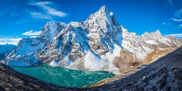 Beas River flowing with snowy blue mountains in Manali Himachal Pradesh
