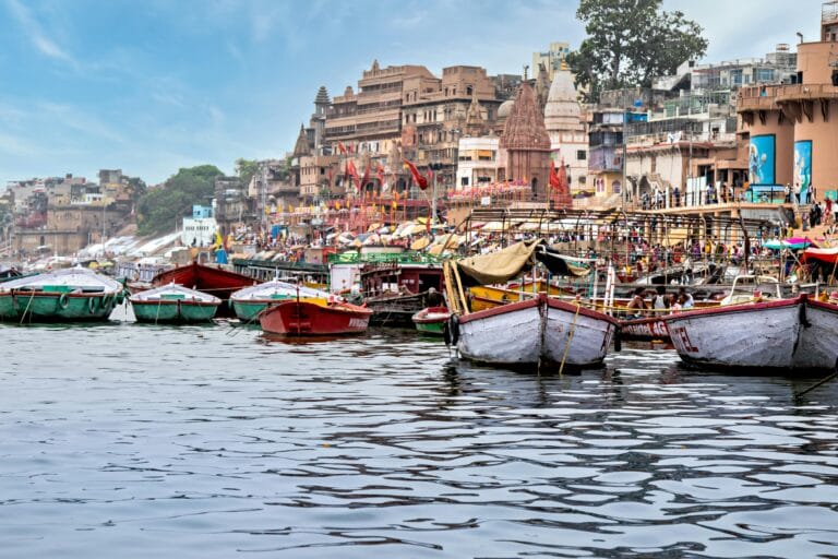 Boats on the Ganga River at Varanasi Ghats with temples in the background