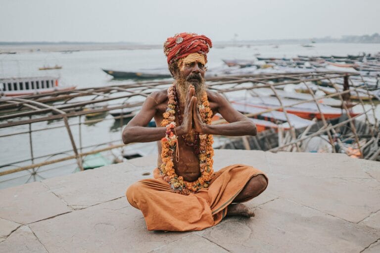 Indian Sadhu sitting at the Ghats of Varanasi with a traditional look
